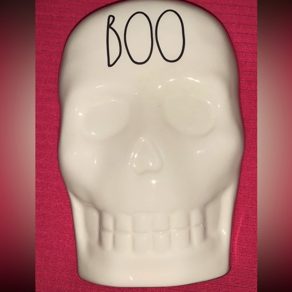 White Rae Dunn Halloween skull decor with Boo script in plain back writing.